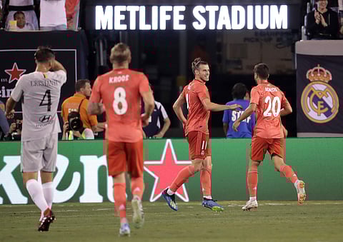 Real Madrid forward Gareth Bale, center, celebrates his goal with midfielder Marco Asensio, right, during the first half of an International Champions Cup tournament soccer match against Roma. (Photo | AP)
