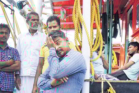 Sunil Das, father of 19-year-old Bipul Das who went missing, and his relatives in Munambam wait for rescue boats to return from search operations | A Sanesh
