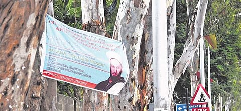 A flex nailed to a tree on Bannerghatta Road | Nagaraja Gadekal