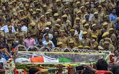 People gather to pay their last respects to DMK chief M Karunanidhi as his cortege passes through the streets of Chennai on Wednesday Aug 8 2018. (Photo | PTI)
