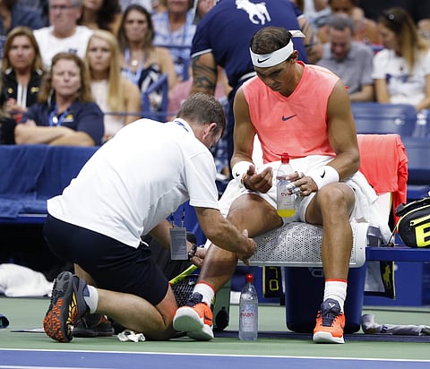 Rafael Nadal is seen by a trainer during the third round of the US Open tennis tournament against Karen Khachanov | AP