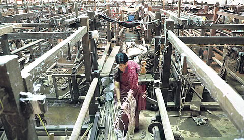 A worker engaged in cleaning the manufacturing unit of Chendamangalam Handloom Weavers’ Cooperative Society in Kochi | Melton Antony