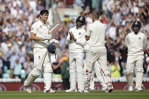 England's Alastair Cook, left, in his last ever batting innings before retiring from test cricket, celebrates reaching his century with his batting partner England's Joe Root, second right, during the fifth cricket test match of a five match series betwee