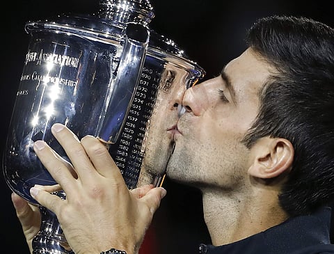 Novak Djokovic, of Serbia, kisses the trophy after defeating Juan Martin del Potro, of Argentina, in the men's final of the U.S. Open tennis tournament, Sunday, Sept. 9, 2018, in New York. | AP