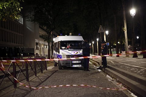 Police officers secure the site of a knife attack in Paris, Monday, Sept. 10, 2018. | AP