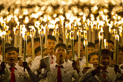 North Korean students take part in a torch light march held in conjunction with the 70th anniversary of North Korea's founding day celebrations in Pyongyang, North Korea. (Photo | AP)