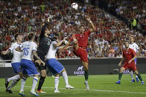 Portugal's Andre Silva, centre, challenges Italy goalkeeper Gianluigi Donnarumma and three Italian defenders during the UEFA Nations League soccer match between Portugal and Italy at the Luz stadium in Lisbon, Monday, Sept. 10, 2018. | AP