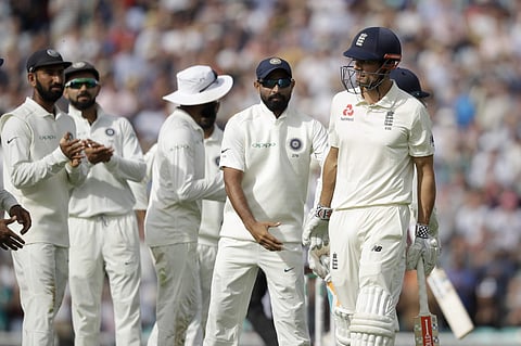 England's Alastair Cook, in his last ever batting innings before retiring from Test cricket, walks off the field of play after losing his wicket from the bowling of India's Hanuma Vihari for 147 runs during the fifth Test match of a five match series betw