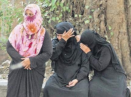 Family of Hameed, one of three men who died on Monday after being run over by a TRSRTC bus, waits to collect his body. | Sathya Keerthi