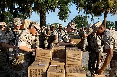 In this photo released by the U.S. Marine Corps, recruits at Marine Corps Recruit Depot Parris Island, S.C., prepare to evacuate to Marine Corps Logistic Base Albany following an evacuation order directed by Brig. Gen. James Glynn, the depot's commanding