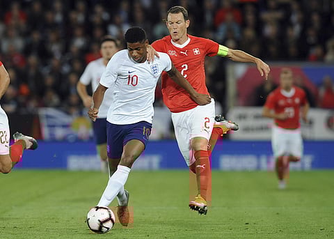 England's Marcus Rashford, left, and Switzerland's Stephan Lichtsteiner challenge for the ball during the International friendly soccer match. (AP)