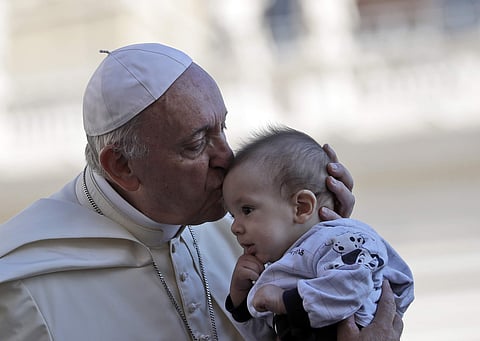 Pope Francis kisses a baby as he arrives in St. Peter's Square at the Vatican for his weekly general audience, Wednesday, Sept. 12, 2018. (Photo | AP)