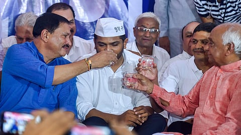 Patidar leaders C K Patel Patidar Naresh Patel and Pralhad Patel offer coconut water to Patidar Anamat Andolan Samiti leader Hardik Patel to breaks his 19 days long indefinite hunger strike in Ahmedabad Wednesday. (Photo | PTI)