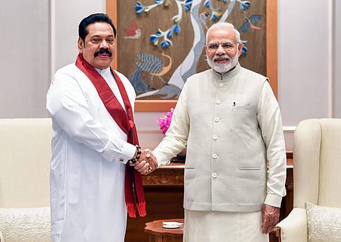 Prime Minister Narendra Modi shakes hands with former Sri Lankan president Mahinda Rajapaksa in New Delhi. (Photo | PTI)