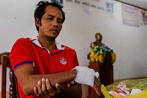 An injured flood victim receives treatment from Vietnamese medical volunteers at a school compound used as evacuation area in Sanamxai, Attapeu province, on July 27, 2018. The torrent of water unleashed in a deadly Laos dam collapse has drained into Cambo