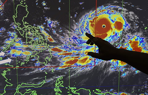 Filipino forecaster Meno Mendoza illustrates the path of Typhoon Mangkhut, locally named 'Typhoon Ompong' (Photo | AP)
