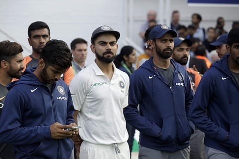 India captain Virat Kohli, center left, waits with his teammates for the trophy presentations to start after England won the fifth Test match and the five-match series between England and India at the Oval cricket ground in London, Tuesday, Sept. 11, 2018