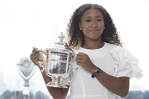 US Open women's singles champion Naomi Osaka poses for photographers with her trophy at Top of the Rock Observation Deck at Rockefeller Center, Sunday, Sept. 9, 2018, in New York. | AP