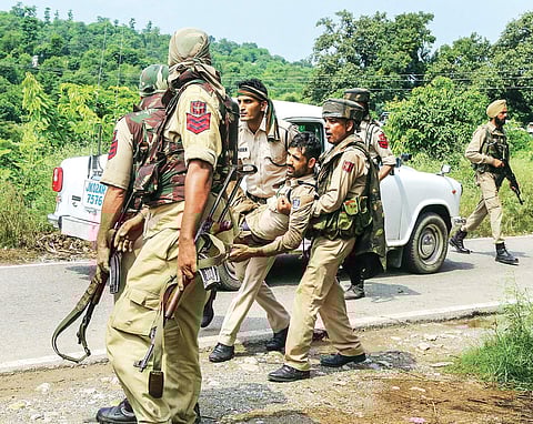 An injured policeman is taken away from an encounter site (Photo | PTI)