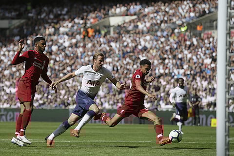 Tottenham's Harry Kane (C) challenges for the ball with Liverpool's Joe Gomez (L) and Trent Alexander-Arnold during the match | AP