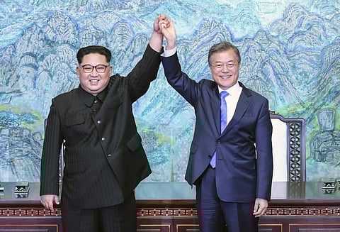 In this April 27, 2018 file photo, North Korean leader Kim Jong Un, left, and South Korean President Moon Jae-in raise their hands after signing a joint statement at the border village of Panmunjom in the Demilitarized Zone, South Korea. (Photo | AP)