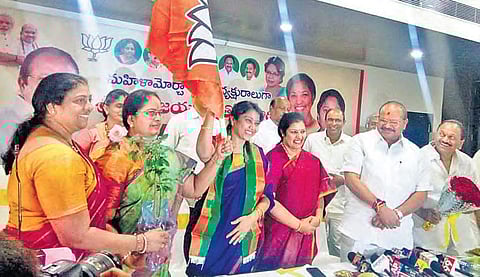 BJP Mahila Morcha State president Thota Vijayalakshmi waves party flag after taking charge, in Vijayawada on Friday | EXPRESS
