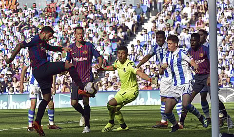 FC Barcelona's Luis Suarez, left, kicks the ball to score next to Real Sociedad's goalkeeper Geronimo Rulli, center, during a Spanish La Liga match between Real Sociedad and FC Barcelona at Anoeta stadium, in San Sebastian, northern Spain. (Photo | AP)