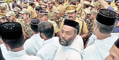Police blocking the priests and believers of the Orthodox faction on the Kayamkulam-Punalur Road at Kattachira on Saturday | Express