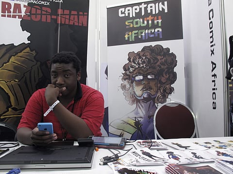 Bill Masuku, a Zimbabwean comic book artist and writer, sits at a stall at Comic Con Africa, a three-day comic book and pop culture convention in Johannesburg, South Africa. (Photo: AP)