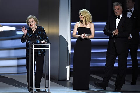 Betty White, left, speaks at the 70th Primetime Emmy Awards on Monday, Sept. 17, 2018, at the Microsoft Theater in Los Angeles. Looking on from right are Alec Baldwin and Kate McKinnon. (Photo: AP)