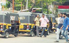Autorickshaw drivers wait for passengers at an auto stand Vincent Pulickal