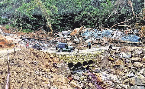 A jeep crosses the makeshift bridge constructed in place of Kundarchola bridge, in Nelliampathy, which was washed away in the flood | Dhinesh Kallungal