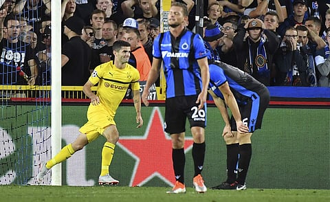 Dortmund's Christian Pulisic, left, celebrates after scoring his side's first goal during the Champions League group A soccer match between Club Brugge and Borussia Dortmund at the Jan Breydel Stadium in Bruges, Belgium, Tuesday, Sept. 18, 2018. | AP