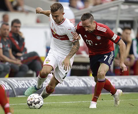 Stuttgart's Anastasios Donis, left, and Bayern's Franck Ribery challenge for the ball during a German Bundesliga soccer match between VfB Stuttgart and Bayern Munich in Stuttgart, Germany, Saturday, Sept. 1, 2018. | AP