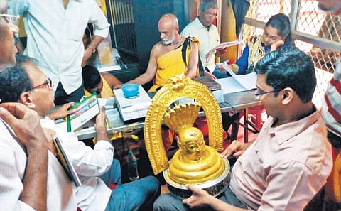Uttara Kannada DC S S Nakul inspecting gold ornaments at Sri Mahabaleshwara temple on Wednesday | Express