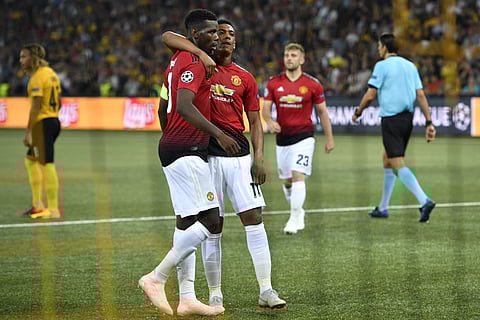 Manchester United's Paul Pogba, left, cheers after scoring (2-0) with Manchester United's Anthony Martial, right, during the UEFA Champions League group H matchday 1 soccer match between Switzerland's BSC Young Boys and England's Manchester United FC in t
