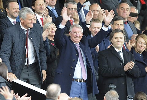 Former Manchester United manager Alex Ferguson waves as he takes his seat on the stands before the English Premier League match between Manchester United and Wolverhampton Wanderers at Old Trafford | AP