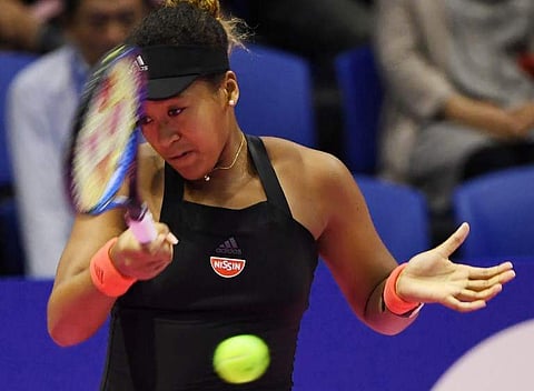 Naomi Osaka of Japan hits a return against Barbora Strycova of Czech Republic during their women's singles quarter-final tennis match at the Pan Pacific Open tennis tournament in Tokyo on September 21, 2018. | AFP