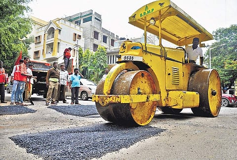 BBMP workers fill potholes near Richmond Town in Bengaluru on Friday | Pushkar V