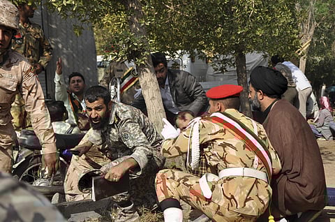 In this photo provided by the Iranian Students' News Agency, ISNA, Iranian armed forces members and civilians take shelter in a shooting during a military parade marking the 38th anniversary of Iraq's 1980 invasion of Iran, in the southwestern city of Ahv