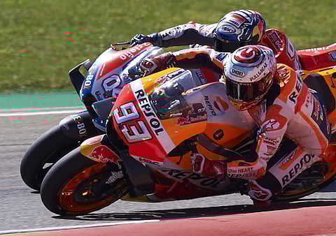 Spain's rider Marc Marquez of the Repsol Honda Team, front, steers his motorcycle followed by Italian rider Andrea Dovizioso of the Ducati Team at the MotoGP race during the Aragon Motorcycle Grand Prix at the Aragon Motorland racetrack in Alcaniz, Spain.
