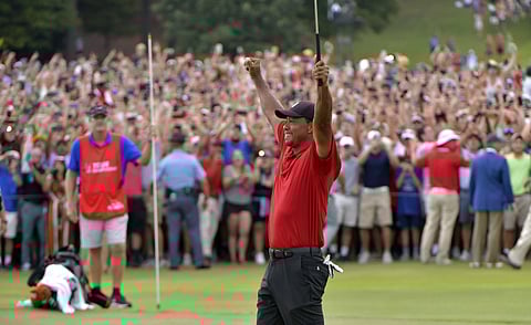 Tiger Woods celebrates after picking up his putt for par on the 18th green to win the final round of the Tour Championship golf tournament. (Photo | AP)