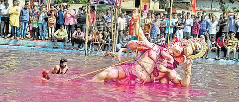 A Ganesh idol being immersed in a tank beside Kapileshwar temple in Belagavi on Monday