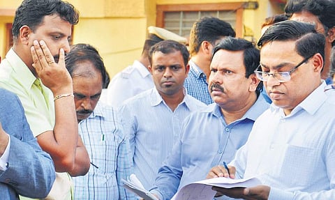 Team members during the inspection of potholes at Maruthi Nagar in Yelahanka on Monday | Pushkar V