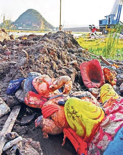 Lord Ganesh idols lie downstream of Prakasam Barrage on the banks of River Krishna in Vijayawada on Monday | P Ravindra Babu