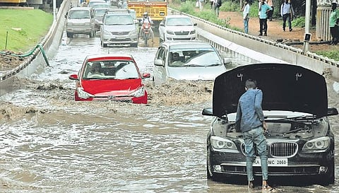 Motorists navigate through a water-logged road under the Hebbal flyover in Bengaluru on Tuesday | Express