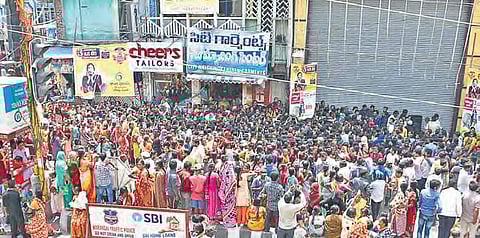 A large number of women who gathered in front of a shopping mall in Warangal on Tuesday, which offered sarees for `3 | Express