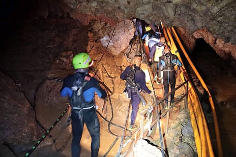 FILE: Thai rescue team members walk inside a cave where the boys are trapped. (Photo | AP)