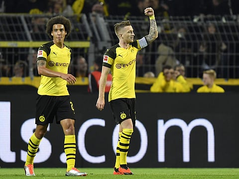 Dortmund's Marco Reus, right, celebrates after scoring his second goal during the German Bundesliga soccer match between Borussia Dortmund and 1.FC Nuremberg in Dortmund, Sept. 26, 2018. (Photo | AP)