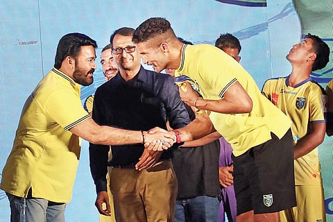 Actor Mohanlal, the new goodwill ambassador of Indian Super League Club Kerala Blasters, head coach David James and players during the launch of the club’s new home kit in Kochi on Wednesday | Melton Antony